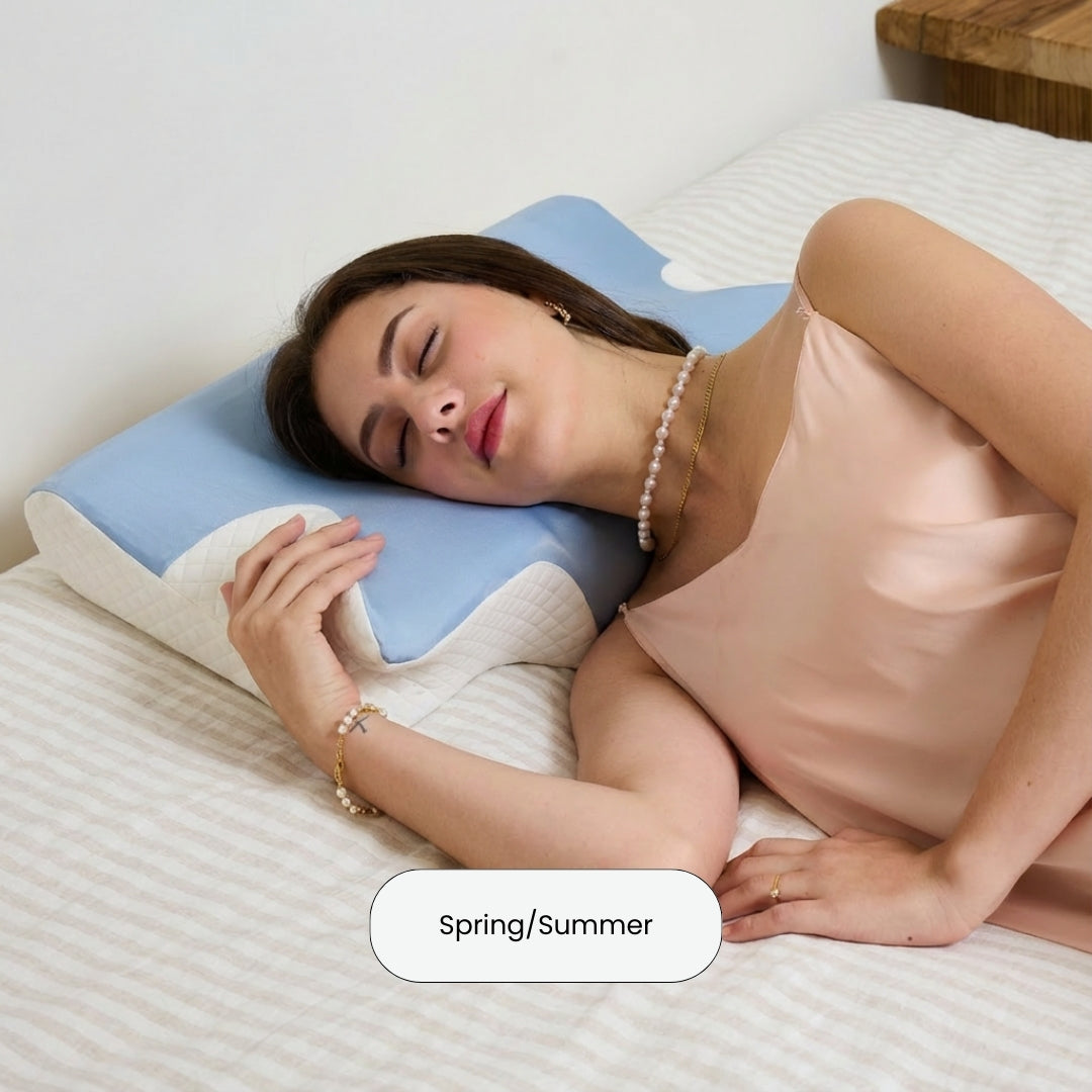 Woman lying on a bed with on an ergonomic cervical neck pillow from serene island